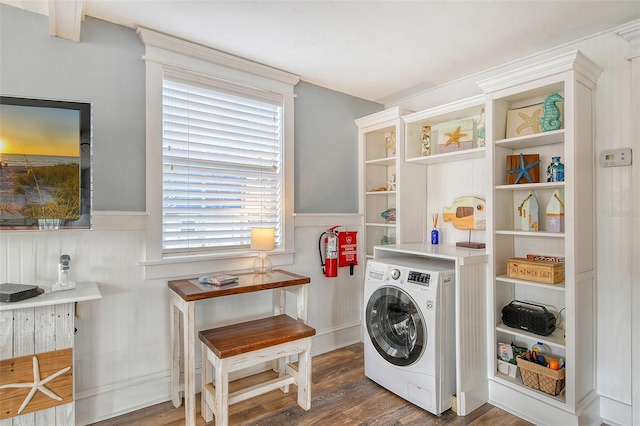 clothes washing area with washer / clothes dryer, dark wood-type flooring, and plenty of natural light