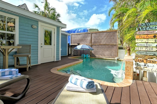 view of pool with a deck and pool water feature