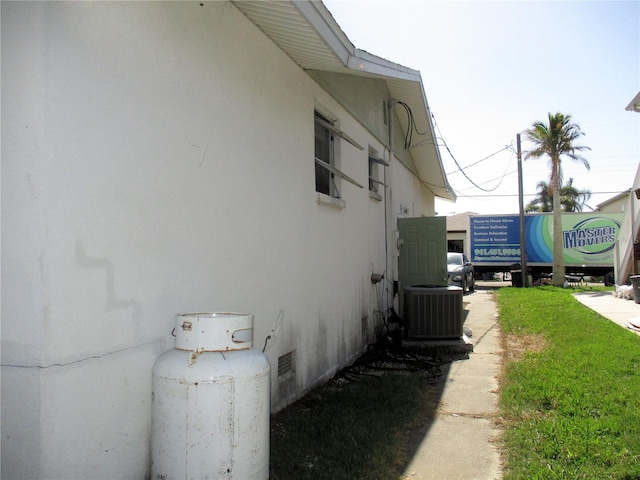 view of side of property with central air condition unit