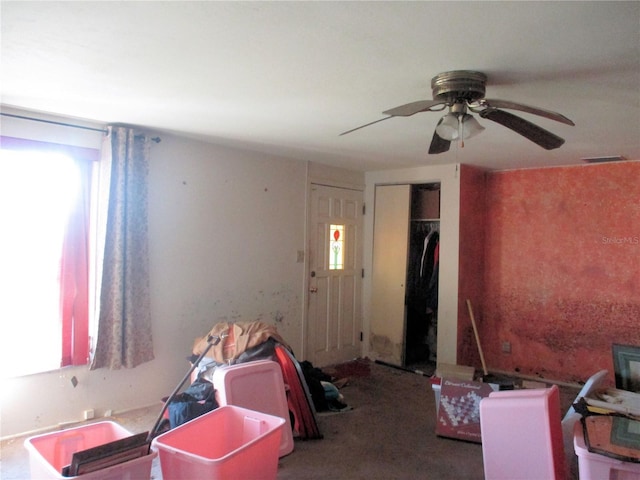 interior space with ceiling fan and visible vents