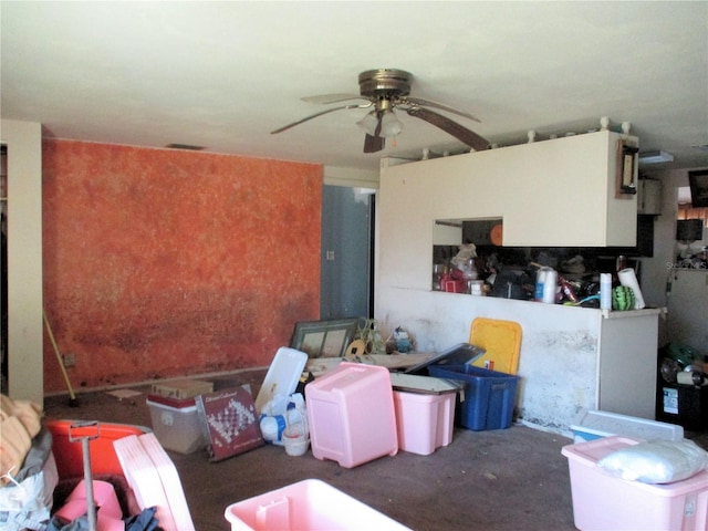 living area with ceiling fan and concrete floors