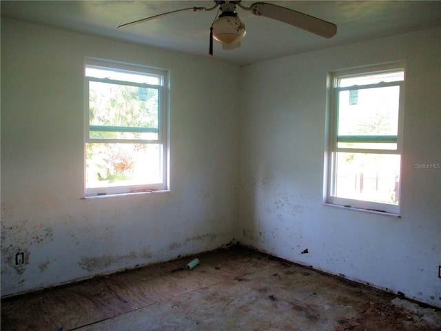 unfurnished room with a wealth of natural light and ceiling fan