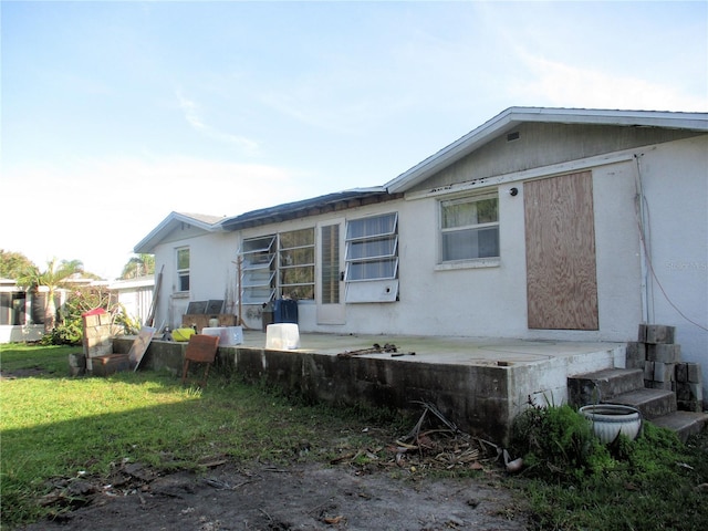 rear view of house featuring a yard