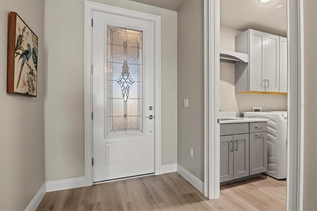 interior space with light hardwood / wood-style floors and washer / clothes dryer