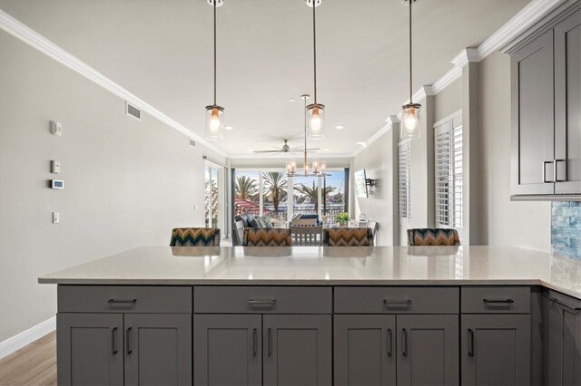 kitchen featuring gray cabinetry and crown molding