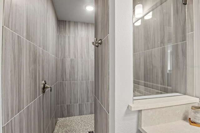 bathroom with a tile shower