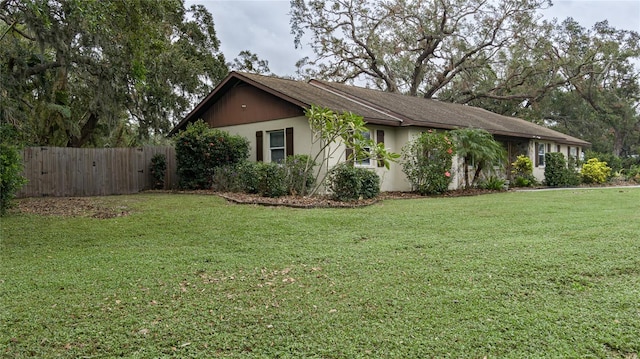 view of side of property with a lawn