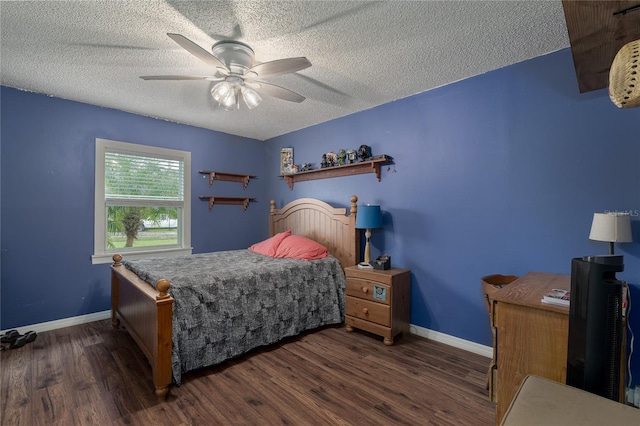 bedroom with dark wood-type flooring, ceiling fan, and a textured ceiling