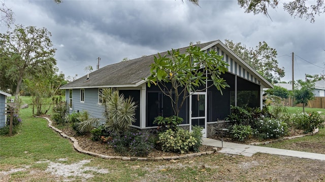 view of front of property with a front lawn and a sunroom