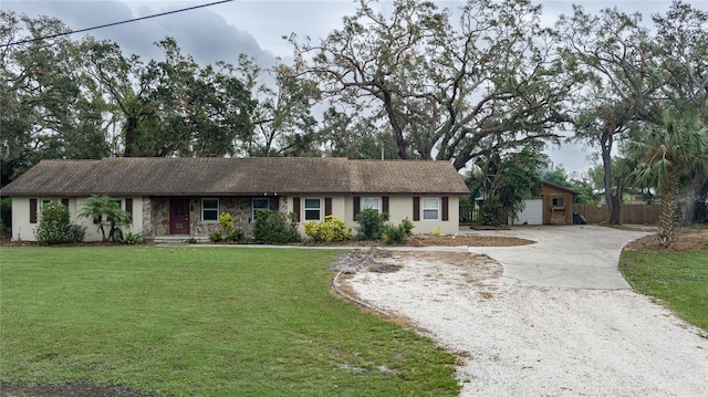 ranch-style home featuring a front yard and a garage