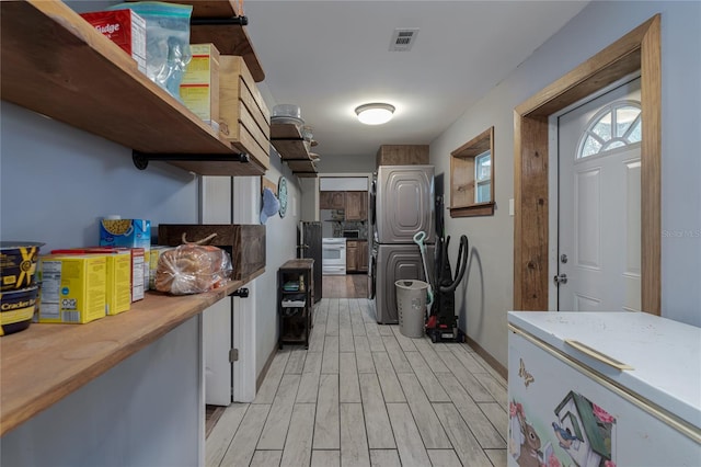 kitchen with stainless steel electric stove and light hardwood / wood-style flooring