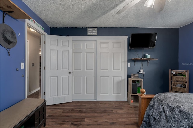 bedroom featuring ceiling fan, dark hardwood / wood-style floors, a textured ceiling, and a closet