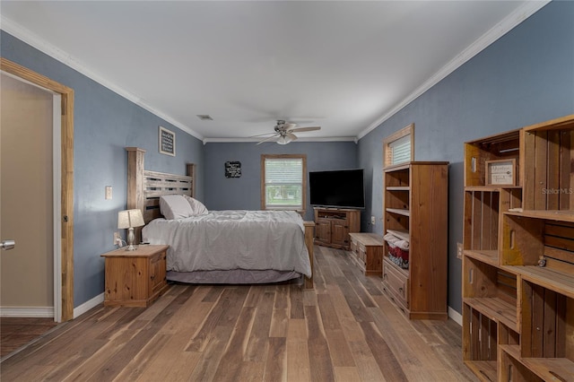 bedroom with dark hardwood / wood-style flooring, ornamental molding, and ceiling fan