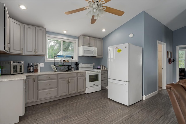 kitchen featuring sink, white appliances, gray cabinets, ceiling fan, and vaulted ceiling