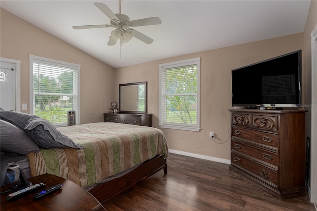 bedroom featuring multiple windows, vaulted ceiling, dark wood-type flooring, and ceiling fan