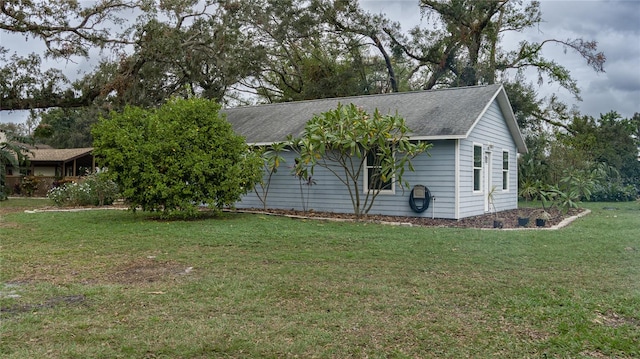 view of side of property with a yard