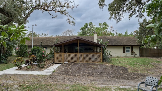 back of property with a sunroom