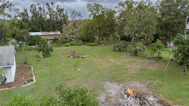 view of yard with a fire pit