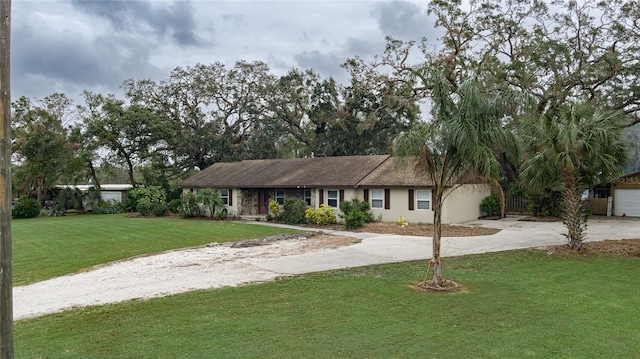 ranch-style home featuring a garage and a front yard