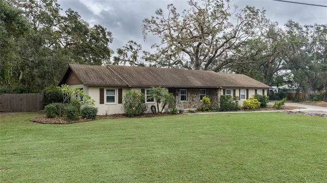 ranch-style home with a front lawn