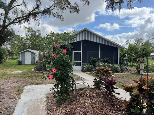 view of outbuilding with a sunroom