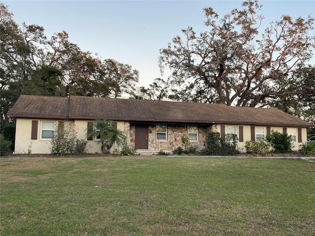 single story home featuring a front yard