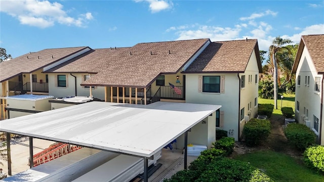 back of house with a balcony