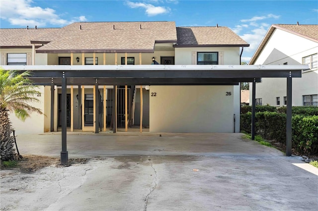 back of house with a carport