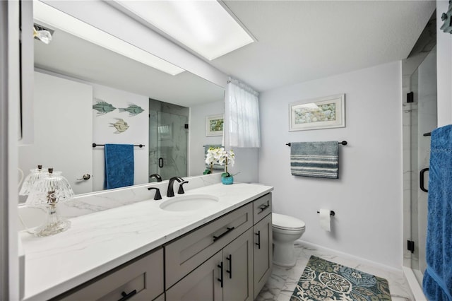 bathroom with a shower stall, baseboards, toilet, marble finish floor, and vanity