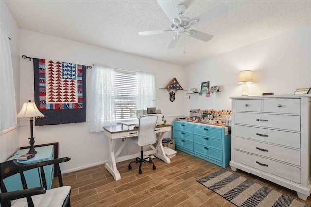 office area featuring baseboards, a textured ceiling, ceiling fan, and wood tiled floor