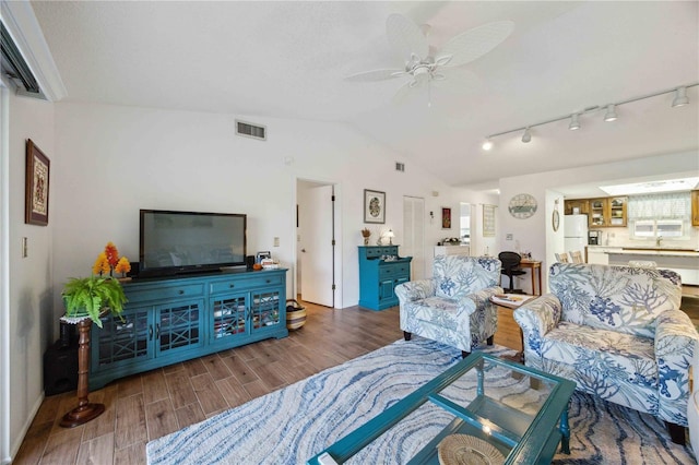 living room with a ceiling fan, lofted ceiling, wood finished floors, and visible vents