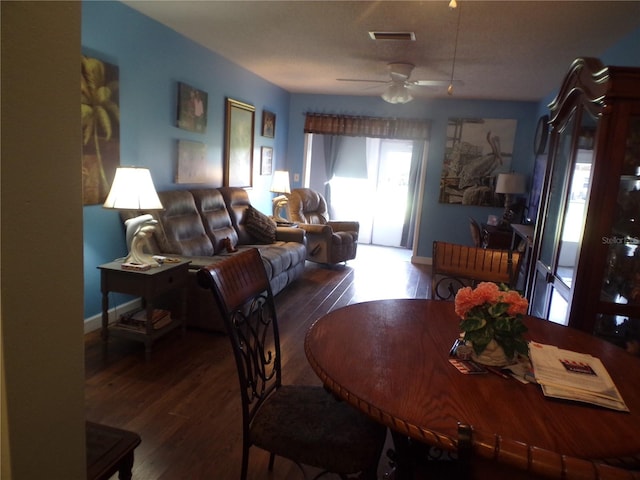 dining space with ceiling fan and dark hardwood / wood-style flooring