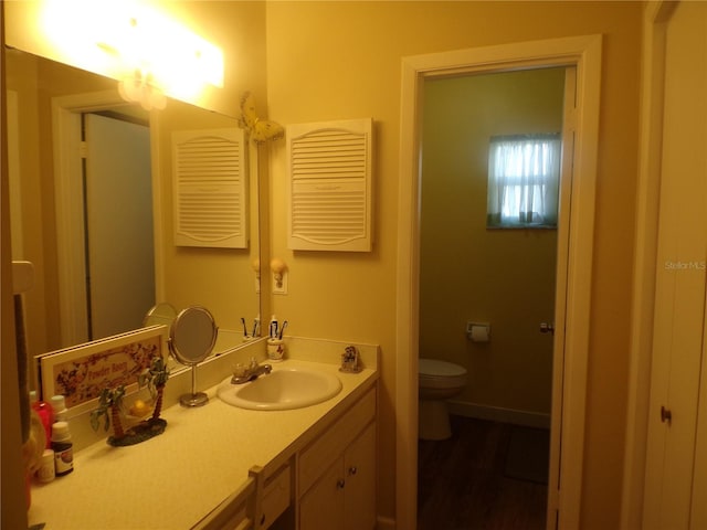 bathroom featuring hardwood / wood-style flooring, vanity, and toilet