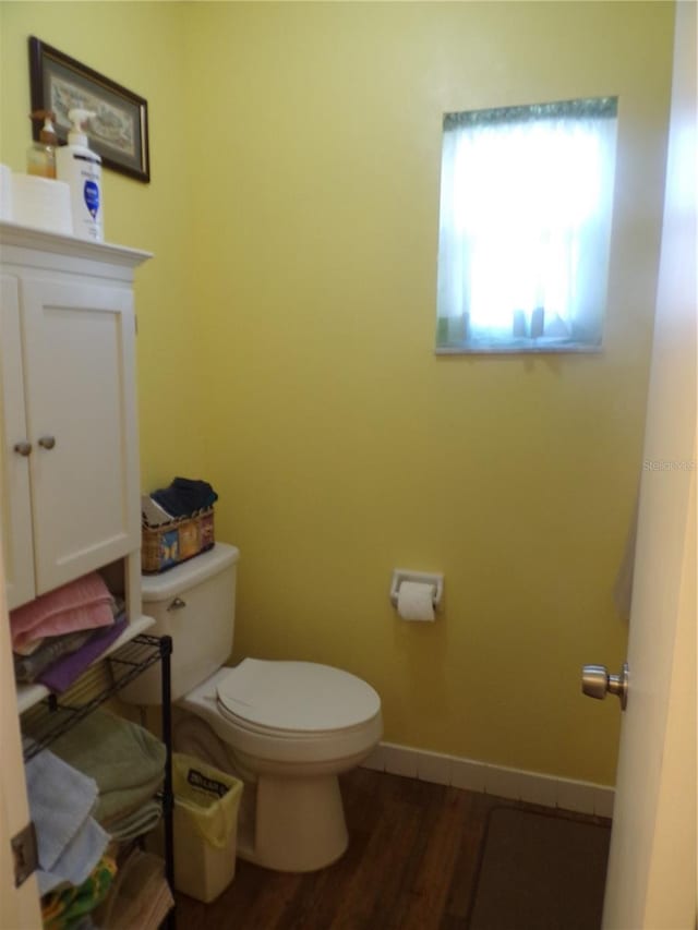 bathroom with hardwood / wood-style floors, vanity, and toilet