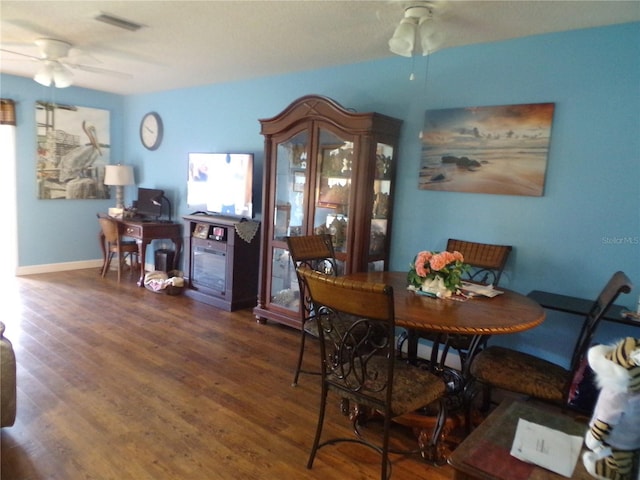 dining space featuring ceiling fan and dark hardwood / wood-style flooring