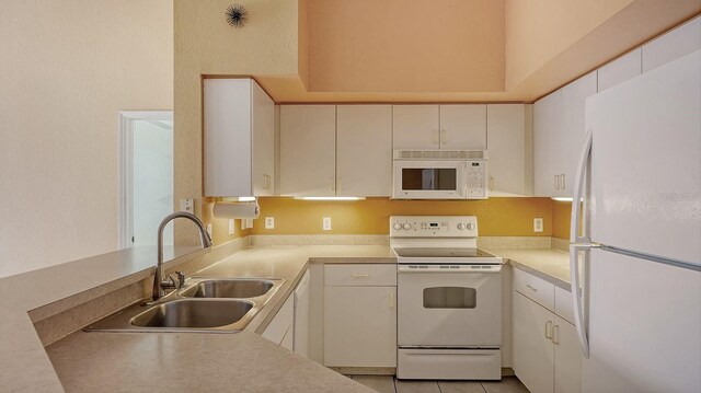 4134 Central Sarasota Pkwy Unit 1734, Sarasota, FL 34238 - kitchen featuring white appliances, a sink, light countertops, and white cabinets