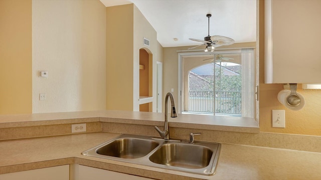 kitchen with ceiling fan, sink, and vaulted ceiling