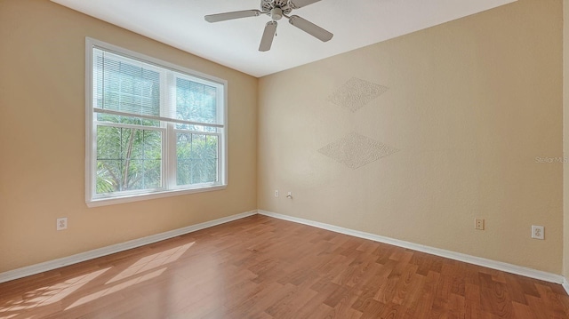 empty room with light hardwood / wood-style floors and ceiling fan