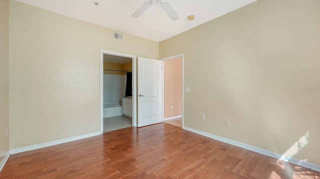 empty room with hardwood / wood-style floors and ceiling fan