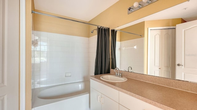 bathroom featuring shower / bath combo with shower curtain and vanity