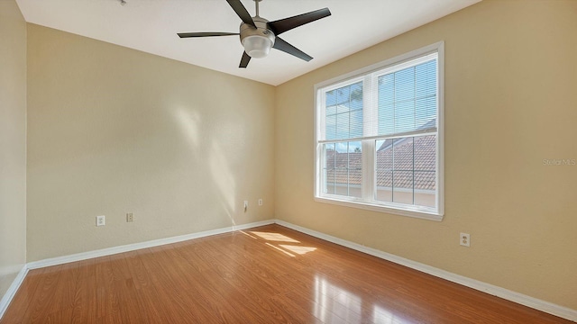 spare room featuring hardwood / wood-style floors and ceiling fan