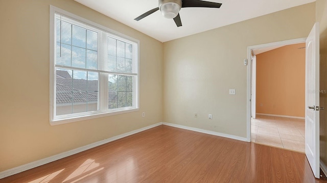 unfurnished room with ceiling fan and light wood-type flooring