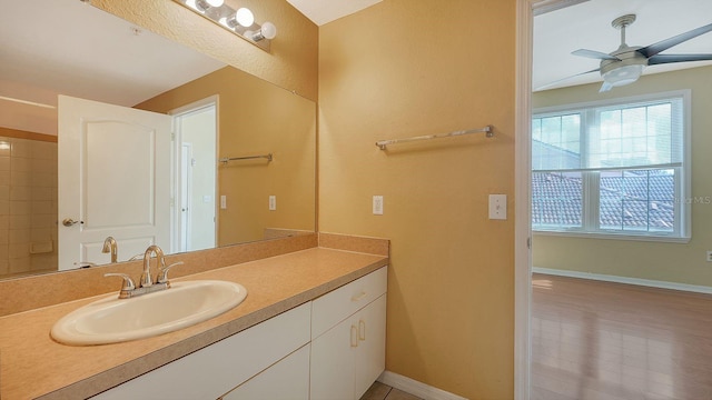 bathroom featuring ceiling fan, vanity, and wood-type flooring