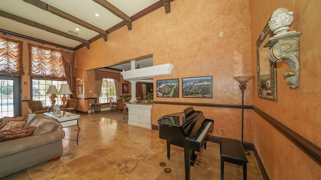 miscellaneous room with a high ceiling, beamed ceiling, tile patterned floors, and ornate columns