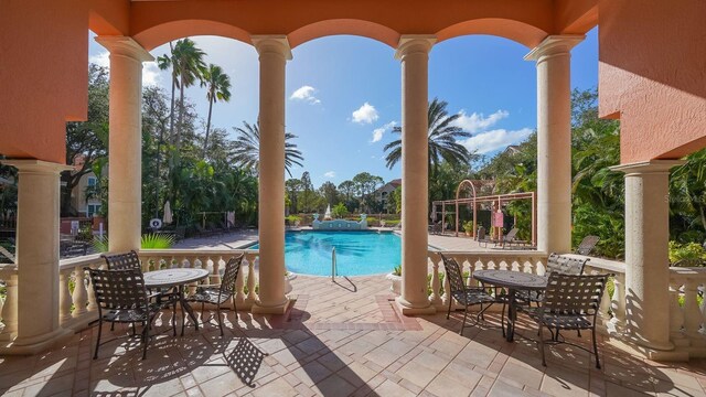 4134 Central Sarasota Pkwy Unit 1734, Sarasota, FL 34238 - view of patio / terrace with a community pool and outdoor dining area