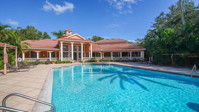 4134 Central Sarasota Pkwy Unit 1734, Sarasota, FL 34238 - community pool featuring a patio area