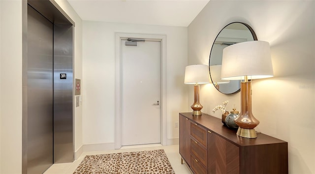 interior space featuring elevator and light tile patterned flooring