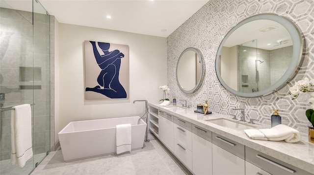 bathroom featuring vanity, backsplash, and independent shower and bath