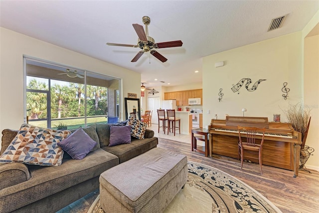 living room featuring hardwood / wood-style flooring and ceiling fan