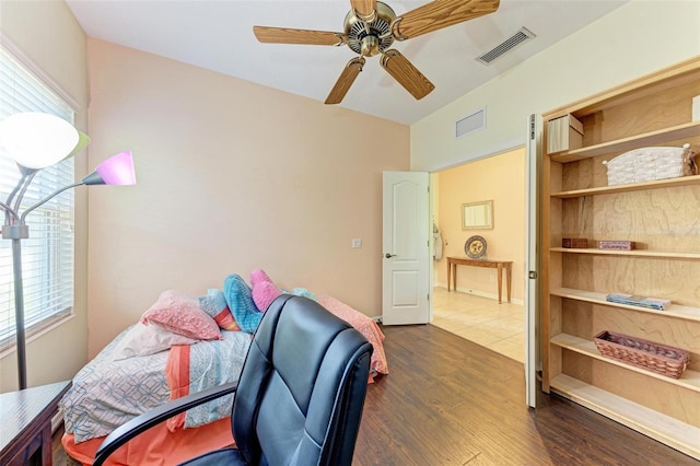 office area with a wealth of natural light, dark hardwood / wood-style flooring, and ceiling fan